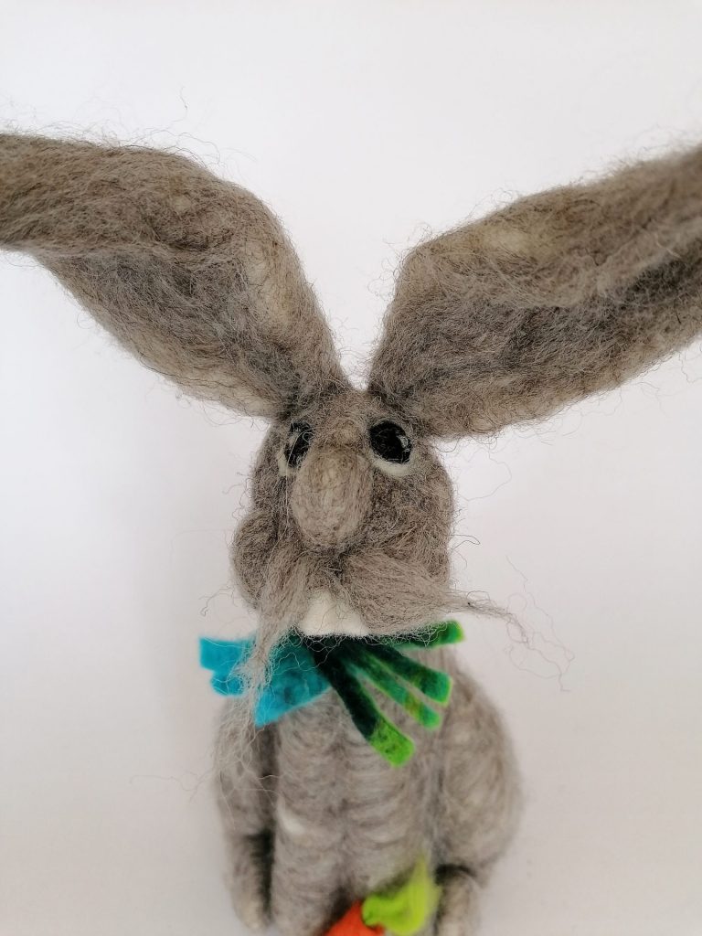 This grey hare is made by sculpting lambs wool fibres and stabbing them with a barbed needle.
